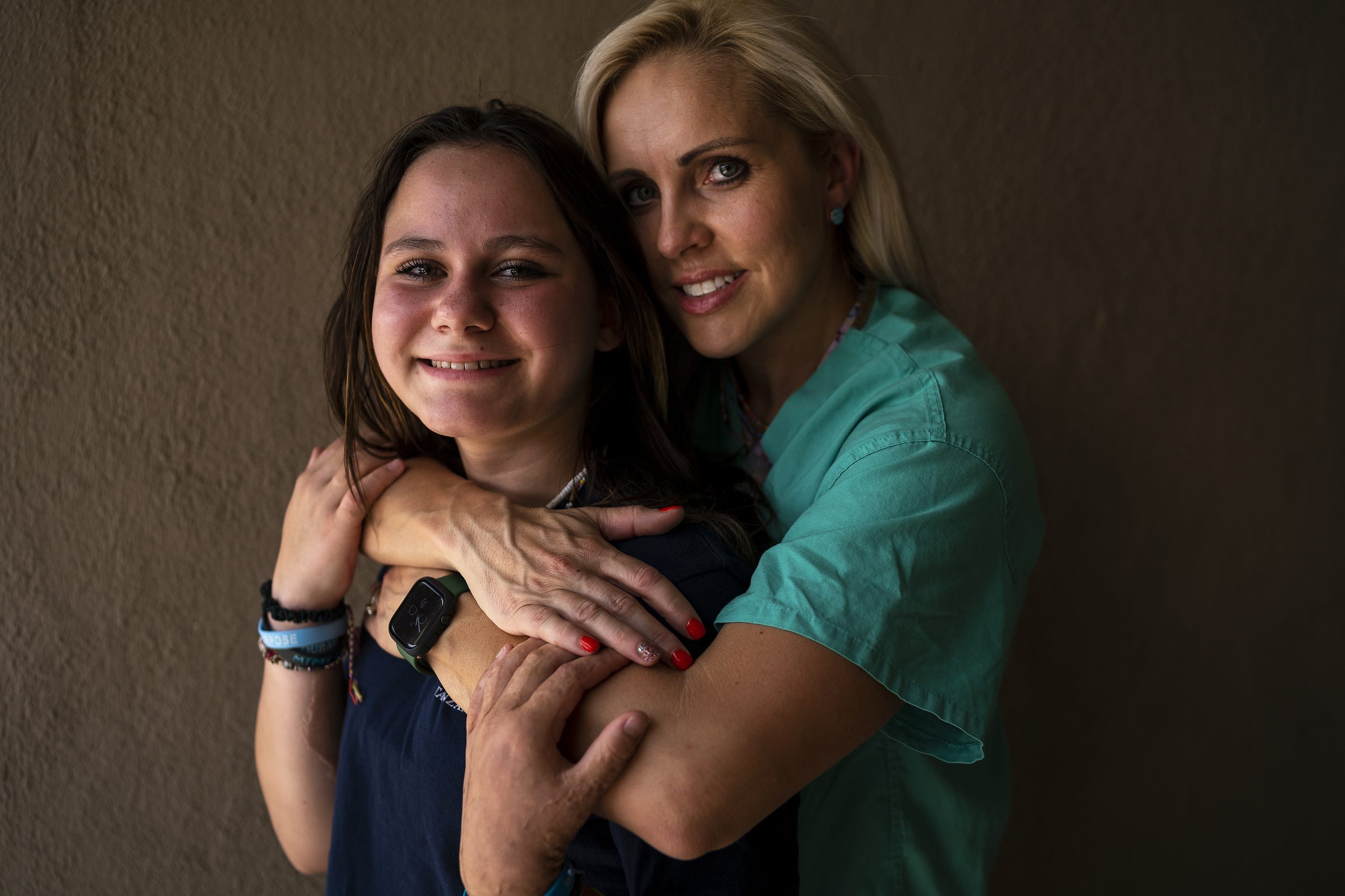 Physical therapist Danika Hines embraces Isabella McCune, 12, at Valleywise Health Medical Center on July 21, 2022, in Phoenix. McCune was burned on over 65% of her body and spent nine months in the hospital. Hines served as her physical therapist for her entire stay.