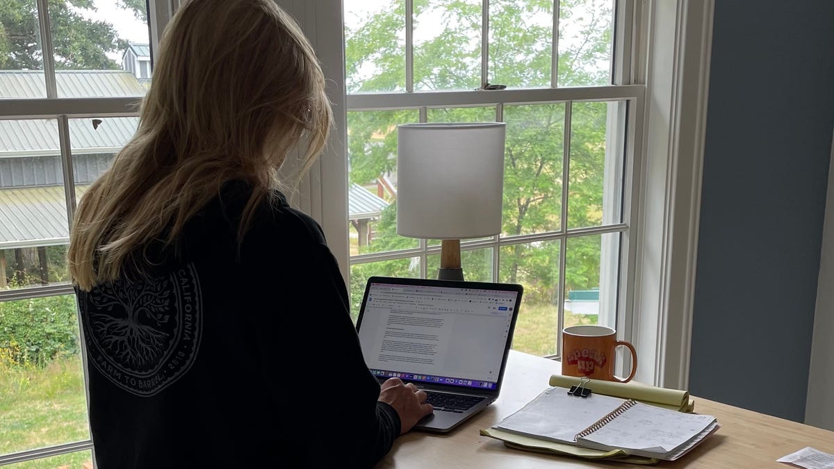 Jolly turned a spare bedroom into her dedicated workspace and types away at a standing desk.