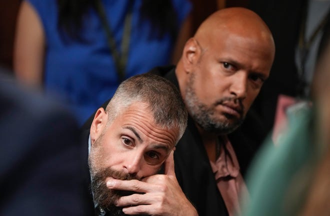 Former DC Metro Police officers Michael Fanone (left) and Harry Dunn listen to testimony during a public hearing before the House select committee to investigate the January 6 attack on the United States Capitol held on July 21, 2022.