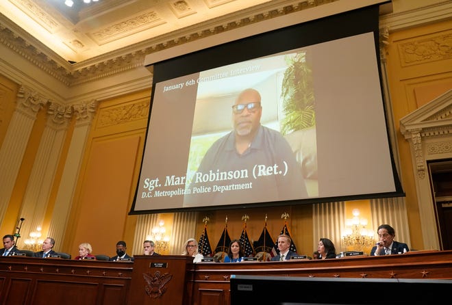 A video of D.C. Metropolitan Police Sgt. Mark Robinson is played during a public hearing before the House select committee to investigate the January 6 attack on the United States Capitol held on July 21, 2022.
