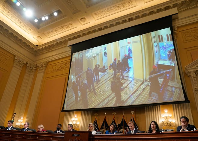 A video clip of rioters breaking into the Capitol is played during a public hearing before the House select committee to investigate the January 6 attack on the United States Capitol held on July 21, 2022.