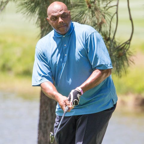 Charles Barkley chips onto the third green during 