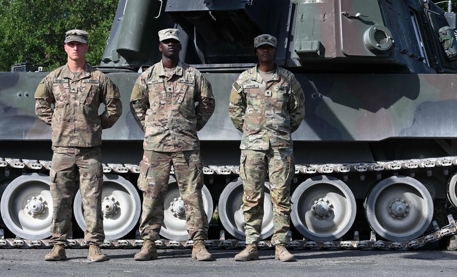 Soldiers of the US Army stand in front of a turreted self-propelled howitzer (M109 Paladin) during the 'Dynamic Front 22', the US Army led NATO and Partner integrated annual artillery exercise in Europe, in Grafenwoehr, near Eschenbach, southern Germany, on July 20, 2022.
