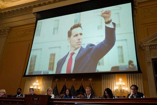 A photograph of Senator Josh Hawley raises his fist at rioters is projected during a public hearing before the House select committee to investigate the January 6 attack on the United States Capitol held on July 21, 2022.