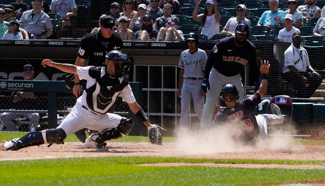 Cleveland Guardians left fielder Steven Kwan (38) slides into home plate as Chicago White Sox catcher Seby Zavala (44) makes a late tag during the ninth inning in game one of a doubleheader at Guaranteed Rate Field.