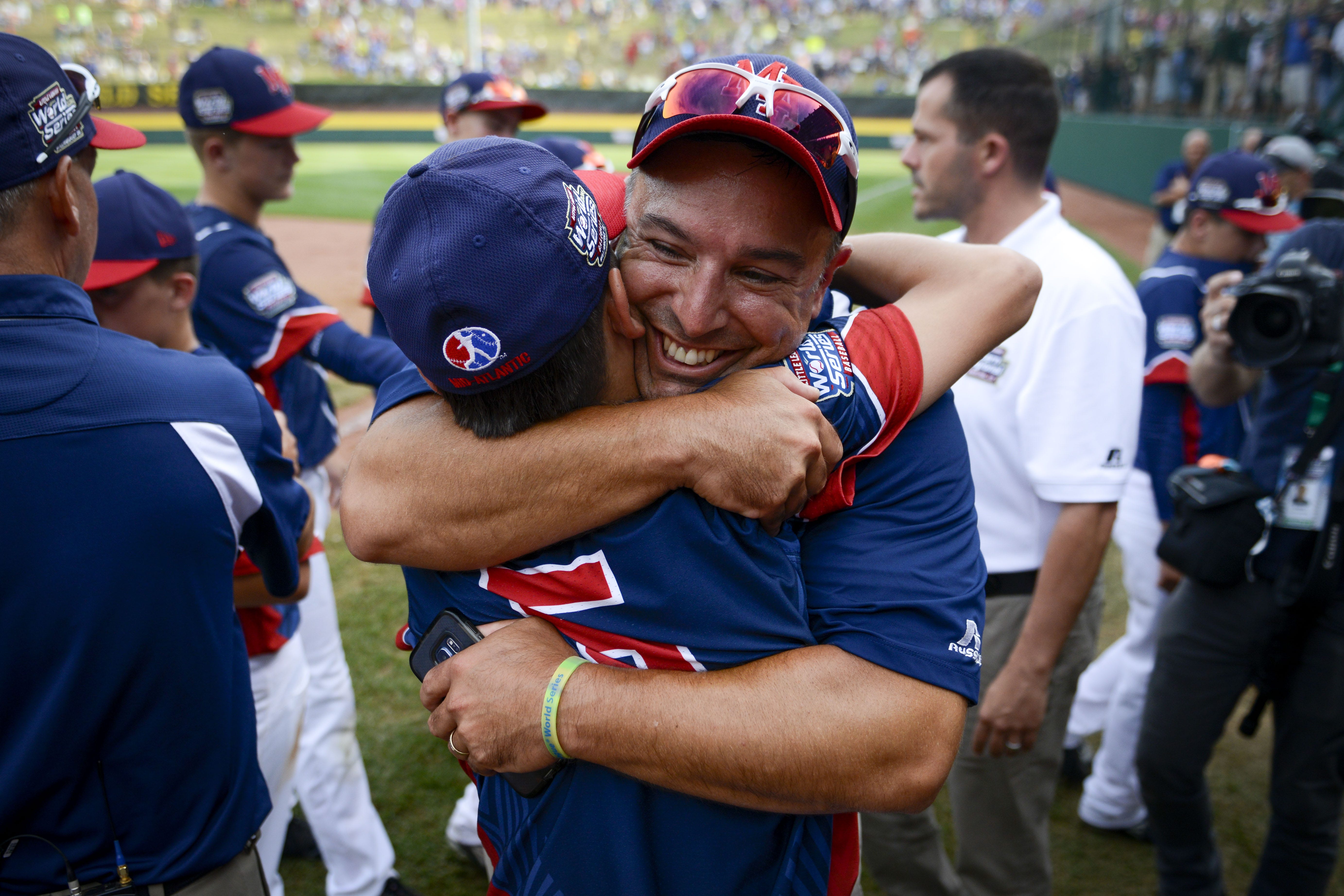 Maine-Endwell assistant coach Joe Mancini celebrates with his son and starting pitcher, Michael, after the U.S. championship game in 2016.