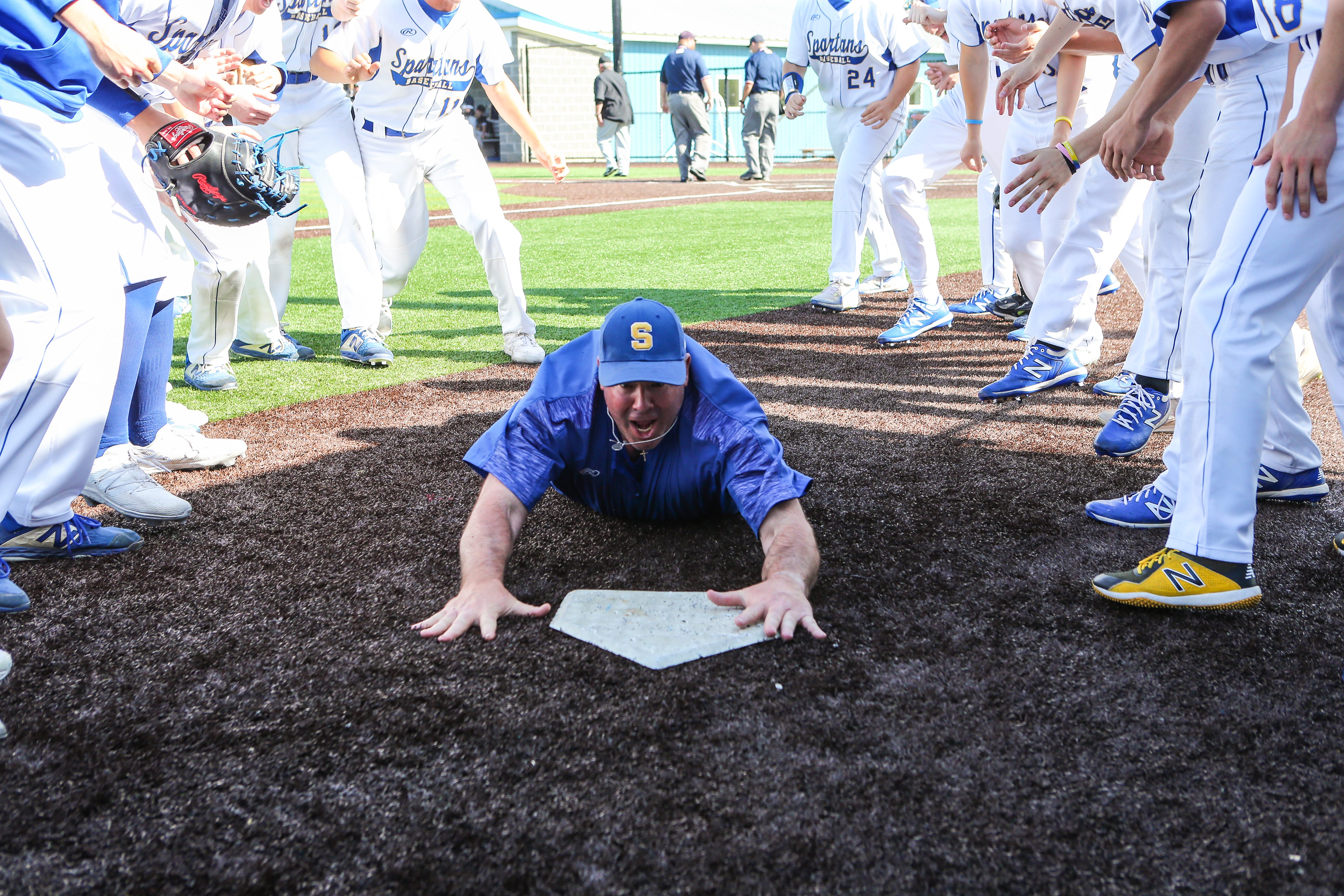 Coach Matt Raleigh celebrates with the Maine-Endwell varsity baseball team after a Section 4 playoff game this spring.