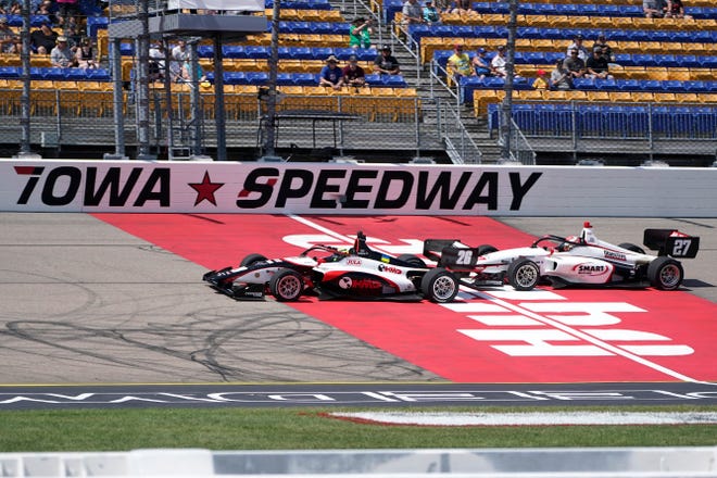 Linus Lundqvist, of Sweden, passes Hunter McElrea, right, during a restart at the Indy Lights Series auto race, Saturday, July 23, 2022, at Iowa Speedway in Newton, Iowa.