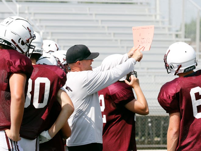 John Glenn coach Matt Edwards goes over a play with the scout team offense during an acclimation day practice on Aug. 21 in New Concord. The Muskies practiced in full pads last week as part of the Ohio High School Athletic Association's early acclimation period.