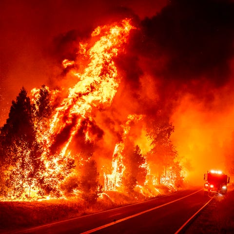 Flames leap from trees as the Oak Fire crosses Dar