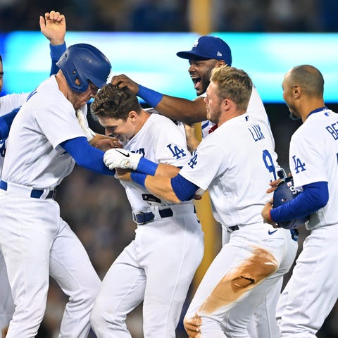 Dodgers catcher Will Smith (middle) is mobbed by h