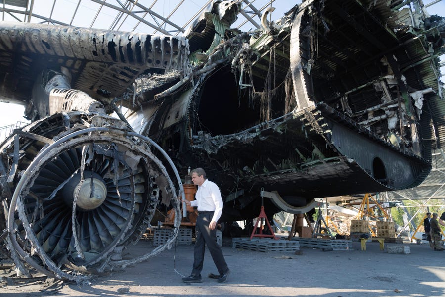 US Rep. Mike Quigley, D-Ill., stands at the gutted remains of the Antonov An-225, world's biggest cargo aircraft destroyed during recent fighting between Russian and Ukrainian forces, at the Antonov airport in Hostomel, on the outskirts of Kyiv, Ukraine, Saturday, July 23, 2022.