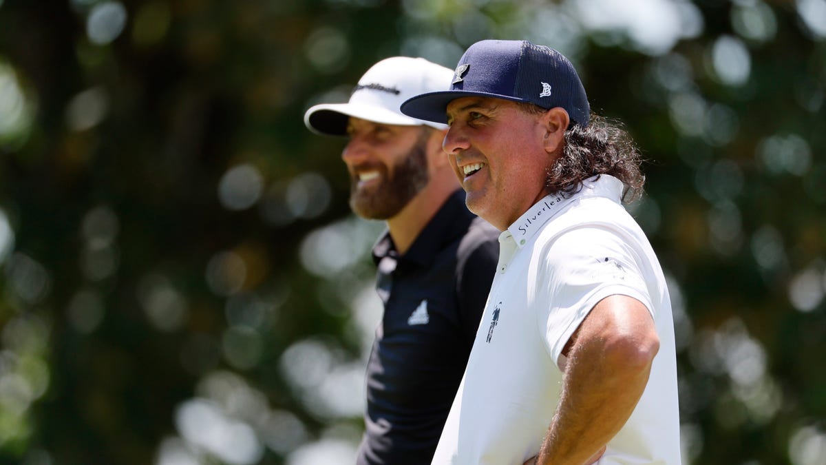 Dustin Johnson (left) talks with Pat Perez during the LIV Golf tournament earlier this month at Pumpkin Ridge Golf Club in Portland, Oregon.