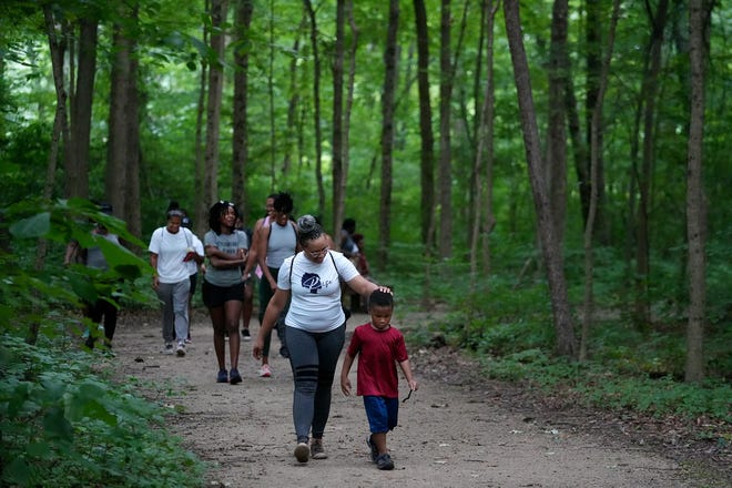 Cass Stewart and her son, Jaiden Harris, 4, lead Rise members along a trail at Blacklick Woods Metro Park in Reynoldsburg. Rise is a branch of Perinatal Outreach and Encouragement for Moms (POEM), a program of Mental Health America of Ohio that provides peer support groups, referrals, and education on pregnancy and mood and anxiety disorders for mothers and families in Ohio.