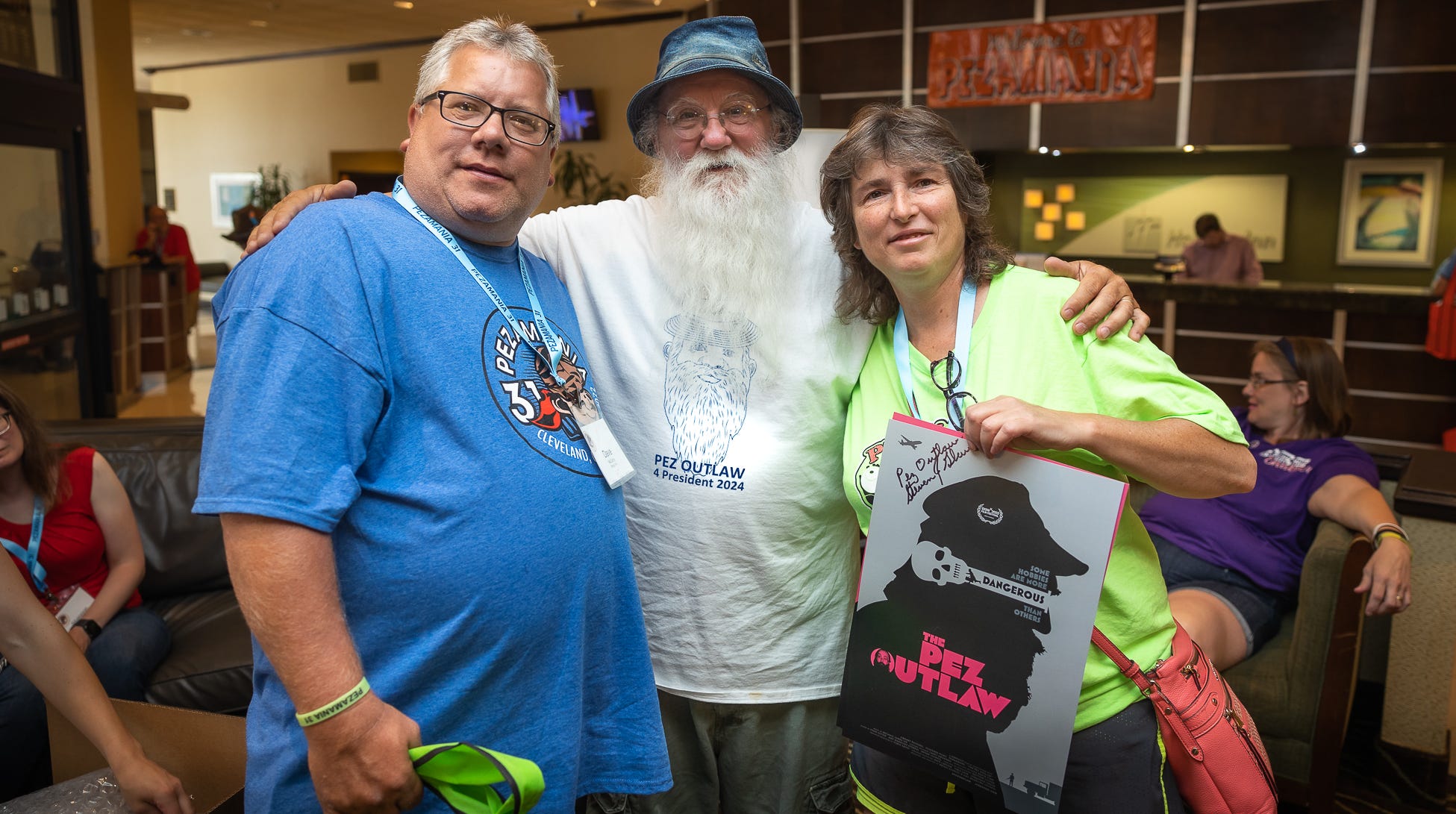 Steve Glew, center, poses with Dave McCarty, left, and Tracy McCarty of Philadelphia at Pezamania in Independence, Ohio, on July 22, 2022. Glew is an attraction at the annual event.