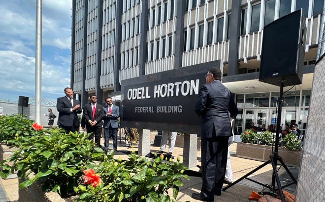 The Horton family pulls down the curtain on the new sign bearing Judge Odell Horton's name, officially naming the federal building in Memphis after Horton alone.