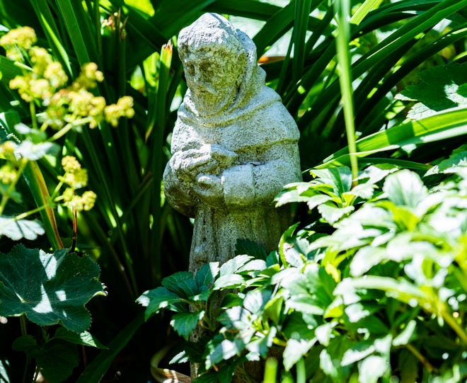 A statue of St. Francis of Assisi stands in Tom Hickey's garden. Hickey likes St. Francis because he's the patron saint of animals.