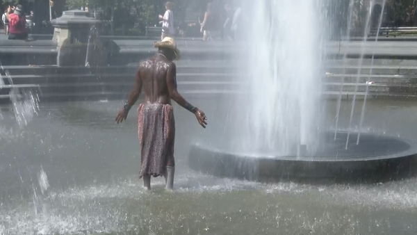 A New York man cools off in a cool water fountain 