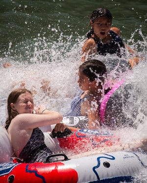 Children enjoy a splash as their tubes head towards the rapids of the San Marcos River near Rio Vista Park in San Marcos on July 26.  July had some of the hottest temperatures of the year.