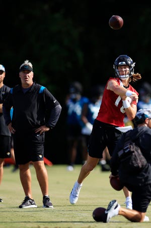 New head coach Doug Pederson watches Trevor Lawrence throw a pass during preseason practice in Jacksonville.