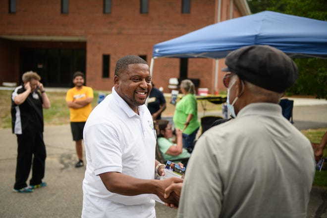 Mayor Mitch Colvin talks to voters as they head in to vote at a polling site at Church of Christ on Tuesday, July 26, 2022.