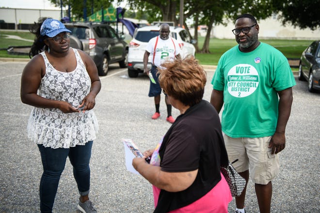 Fayetteville City Councilwoman Shakeyla Ingram and City Council candidate Tyrone Williams, both running for the District 2 spot, talk with a voter as she heads in to vote at Fayetteville Fire Station 1 on Tuesday, July 26, 2022.