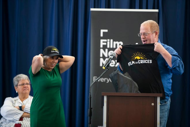 New Mexico Gov.  Michelle Lujan Grisham, left, receives Film Las Cruces swag from state Sen.  Jeff Steinborn, president of Film Las Cruces, right, during the satellite film school announcement at Doña Ana Community College on Tuesday, July 26, 2022.