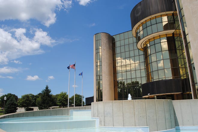 Livonia City Hall with the United States, State of Michigan and City of Livonia flags flying in July 2022.