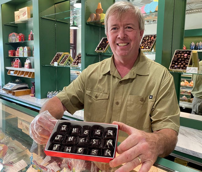 Randy Collick with a box of chocolates made with hot pepper filling. Options include jalapeno, scorpion and Carolina Reaper. The box of hot chocolates is one of new ideas the Collicks have for the longtime candy shop.