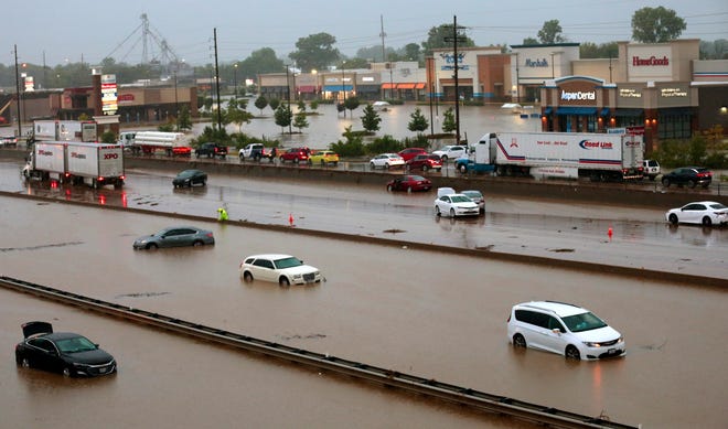 Abandoned cars are scattered by flooding across a shuttered Interstate 70 at Mid Rivers Mall Drive in St. Peters after heavy rain fell through the night and into the morning on Tuesday, July 26, 2022.