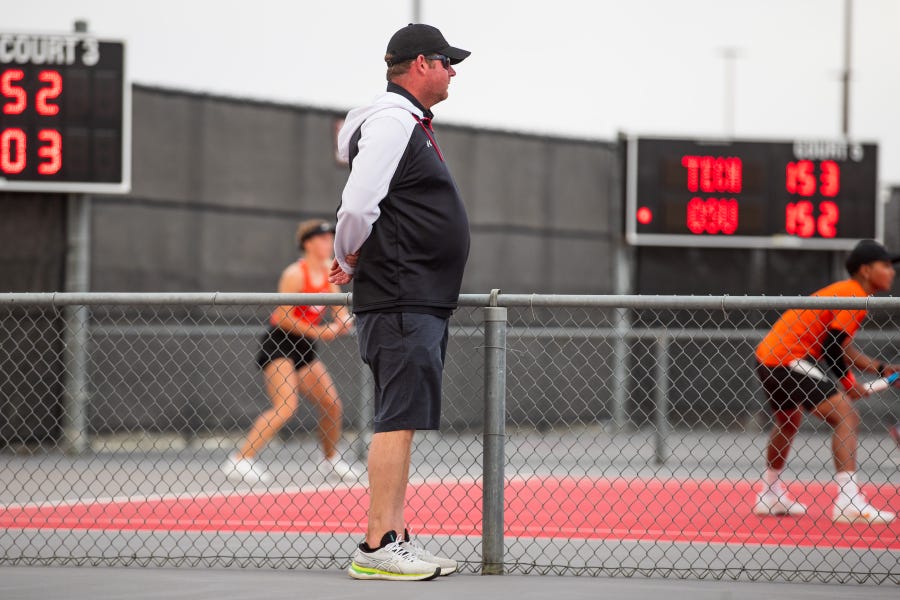 Texas Tech head coach Todd Petty looks on during the match against Oklahoma State on Friday, April 1, 2022, at McLeod Tennis Center in Lubbock, Texas.