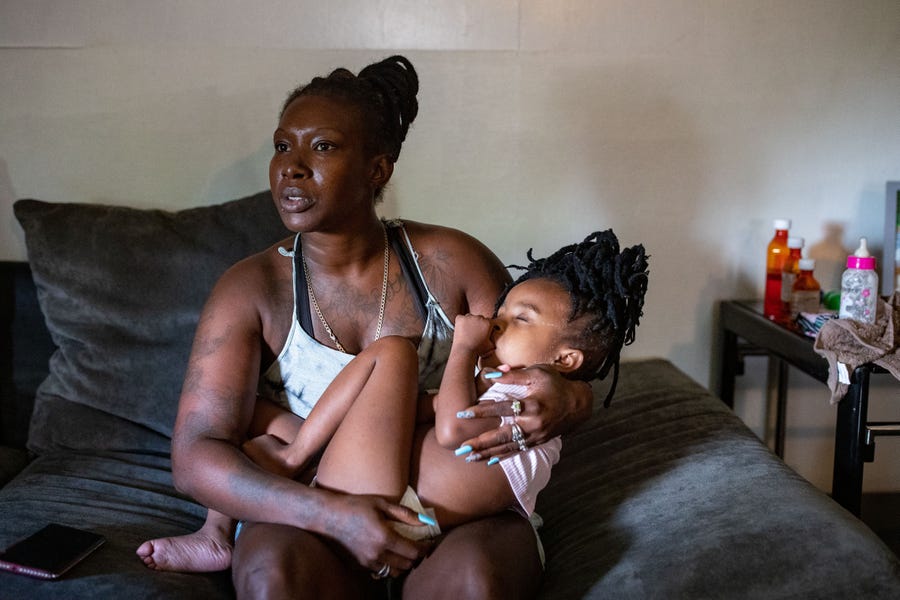 Chrisstine 'Chrissy' Daniels holds her daughter, TeSharria, 5, as she recalls the struggles she had during her pregnancy Wednesday, July 6, 2022. Daniels had high blood pressure throughout her pregnancy with Tesharria and suffered from headaches and severe swelling as she developed preeclampsia while going into labor at a now-shuttered Lake City hospital.