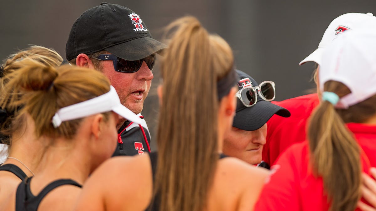 Todd Petty, shown talking to his players during a match against Oklahoma State on April 1, stepped down as women's tennis coach June 30.