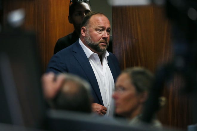 Alex Jones entered the courtroom in front of Scarlett Lewis and Neil Heslin, parents of Sandy Hook shooting victim, 6, Jesse Lewis, at Travis County Courthouse Wednesday, July 27, 2022.
