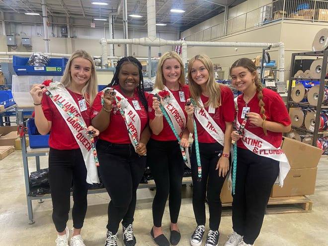 The young women competing for the title of Greater Alliance Carnation Festival queen visited Coastal Pet Products as part of a daylong outing in which they learned about the city's businesses and agencies. Holding keychains and lanyards made from material Coastal Pet uses to make leashes and collars for dogs and cats are contestants, from left, Olivia Bertolini, representing Alliance Dairy Queen; Kayla Martin, representing R.L. Xperience; Abbey Wilson, representing Expressions Salon; Kenna McElroy, representing MAC Trailer; and Catarina Hagan, representing Hagan Heating & Plumbing.