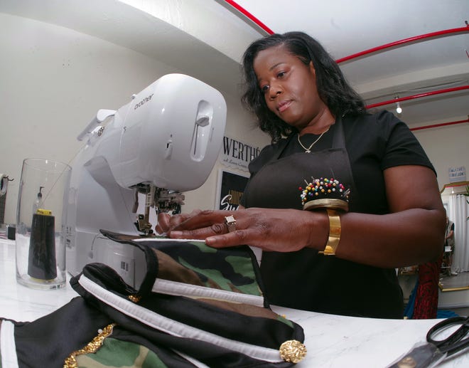 Custom fashion designer Jawanda Evans of Brockton, owner of Werthe by Jem, works on a garment in her Brockton studio on Tuesday, July 26, 2022.