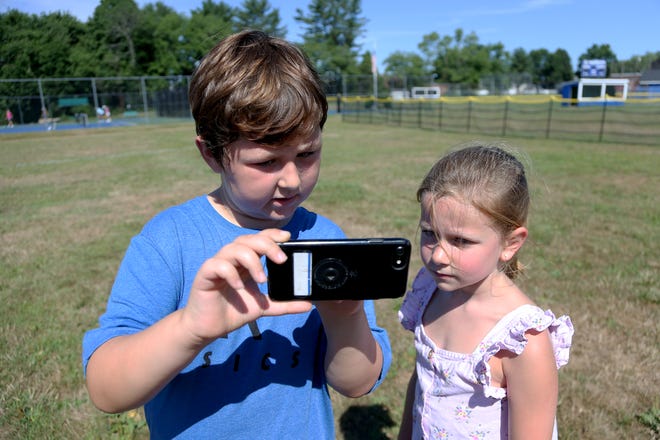 From left, campers Ali Larhrib and Morgan Remick participate in Magical Park, a new program that transforms Tuck Field into a digital playground.