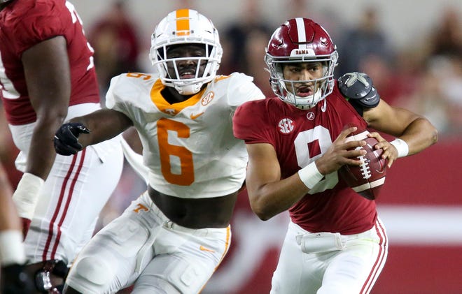Oct 23, 2021; Tennessee defensive lineman Byron Young (6) attempts to bring down Alabama quarterback Bryce Young (9) at Bryant-Denny Stadium. Alabama defeated Tennessee 52-24. Mandatory Credit: Gary Cosby Jr.-USA TODAY Sports