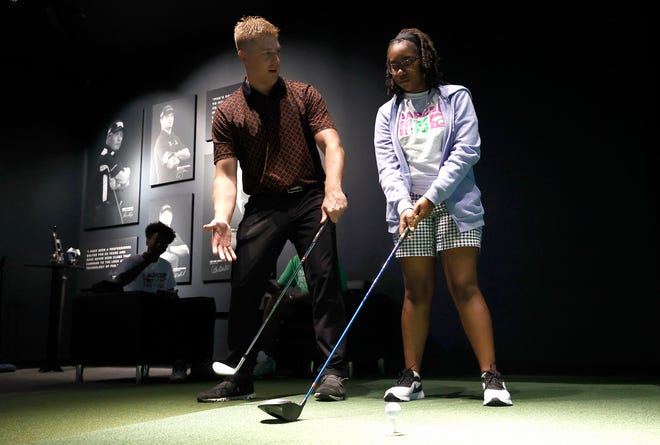 Mark Lahnala, 32, of South Lyon, left, who is a fitting specialist at PXG (Parsons Extreme Golf) in Troy, works with Lorelei Phiri, a ninth grader at Cranbrook Schools, during the one-day DAPCEP camp on July 27, 2022 Nineteen students from the metro Detroit school learned the science and engineering of golf from the clubs to ball striking.
