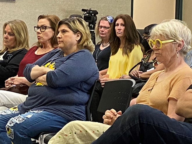 A room full of people attended the Fairfield Township Board's public hearing on Wednesday, July 27, 2022. The meeting was to get input about whether to remove Trustee Taletha Coles, seen here before the meeting in the yellow shirt and dark hair.