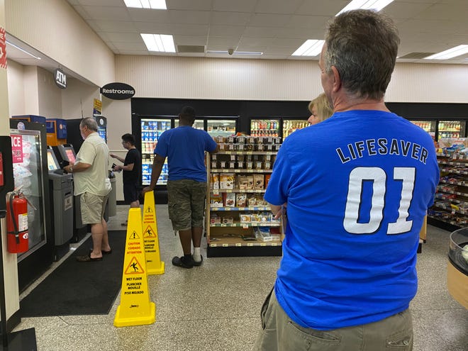 Delaware Lottery customers wait in line at a Wawa in Talleyville to use the store's self-service lottery ticket kiosk ahead of the Mega Millions drawing on Tuesday, June 26, 2022.