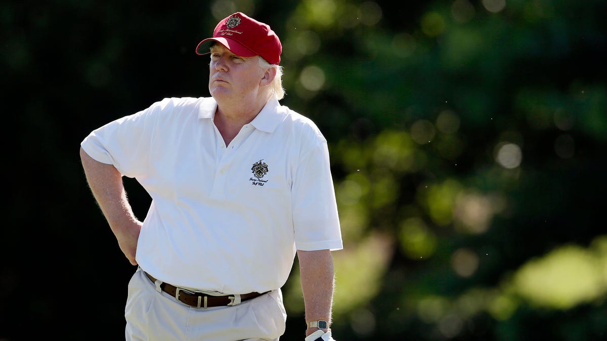 In this June 27, 2012, file photo, Donald Trump stands on the 14th fairway during a pro-am round of the AT&T National golf tournament at Congressional Country Club in Bethesda, Md.