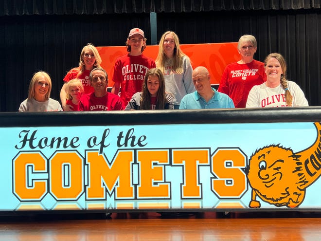 Natalie Doyle is joined by her family and Jonesville coaches at her national signing day.