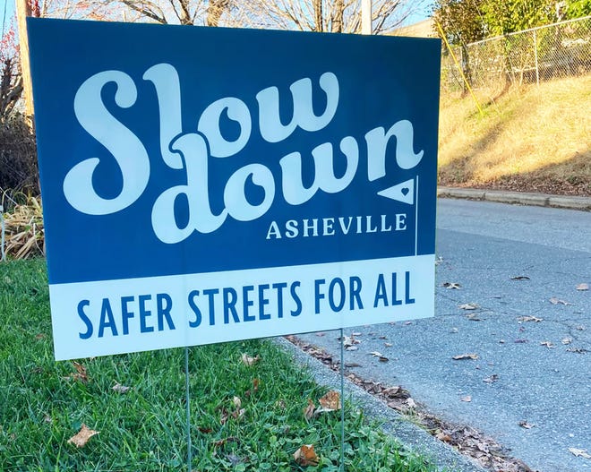 Yard signs created by graphic designer Amanda Wilde encouraging Asheville drivers to slow down.