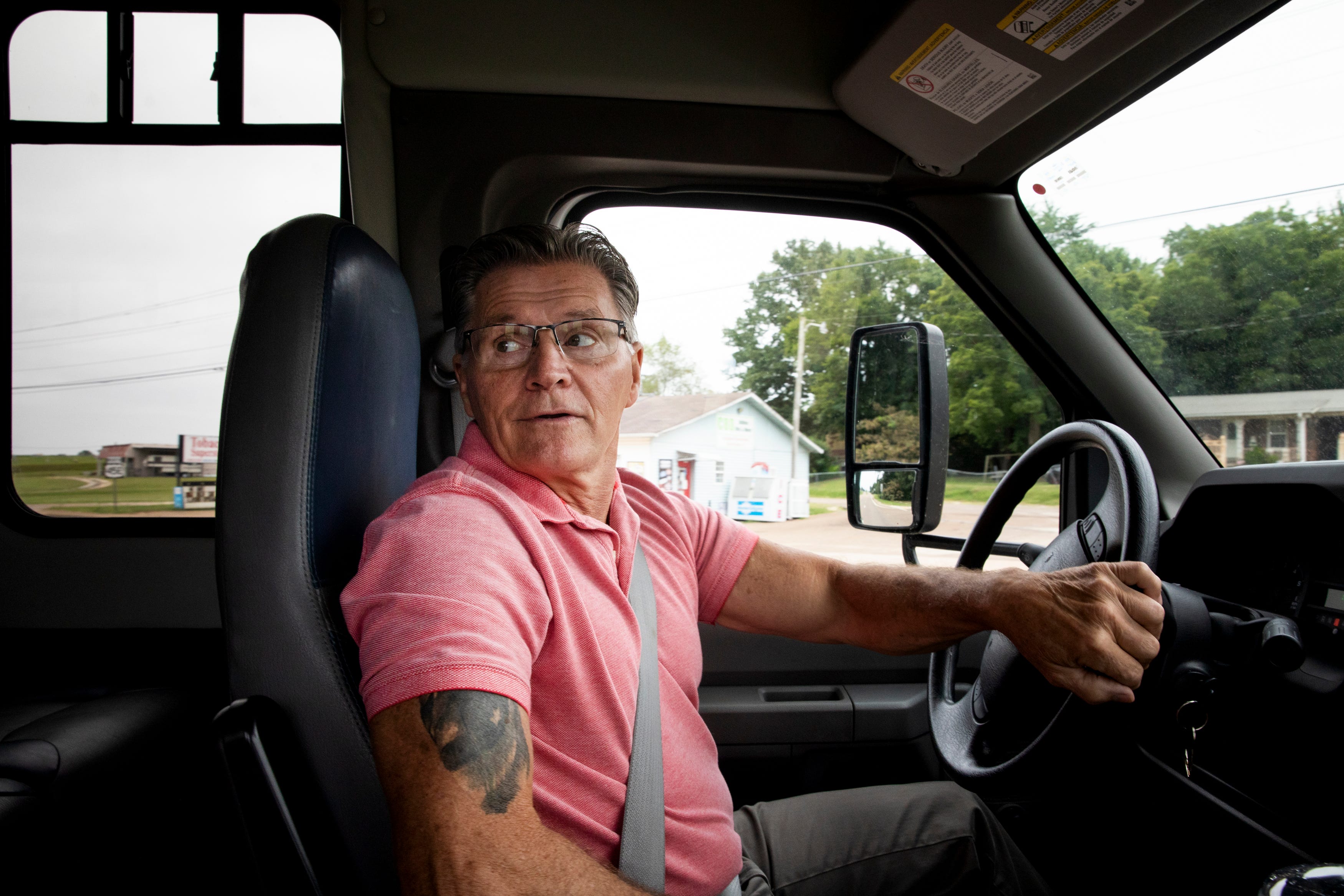 Mark McAlister drives the church bus to pick up people before the Sunday Service on Sunday, August 15, 2021, in Greenfield, Tenn.
