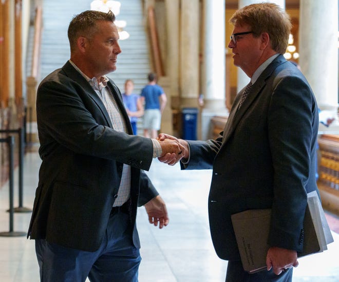 Tom McDermott (left), mayor of Hammond, Ind., visits with State Rep. Phil GiaQuinta inside the Indiana Statehouse on Thursday, July 28, 2022, just as the House goes into recess. 