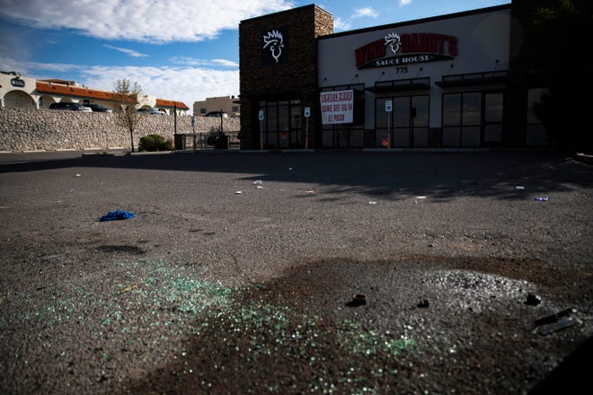 Shattered glass remains Thursday, July 28, 2022 in the parking lot of Wing Daddy's, the site of a police shootout the evening before.