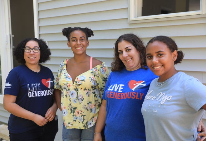 From left, Narissa Walker, Madison Victor, Kimberlee Girolamo and Aaliyah Victor outside their home in Wappingers Falls on July 28, 2022. Girolamo and her daughters are recipients of a Habitat for Humanity home and will be moving in to the house in early August.