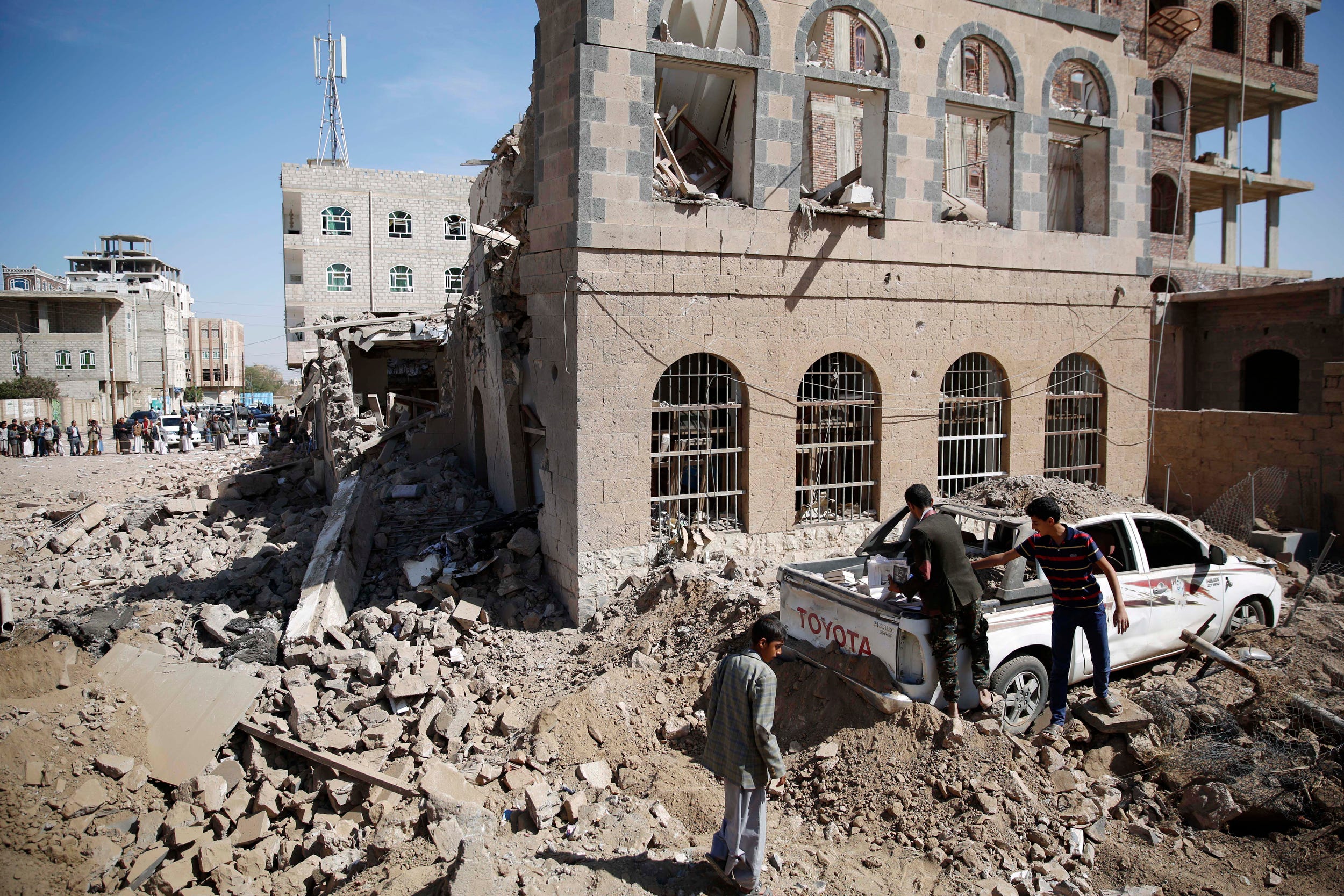 Shiite rebels, known as Houthis, inspect amid a house destroyed by Saudi-led airstrikes in Sanaa, Yemen, Wednesday, Oct. 28, 2015.