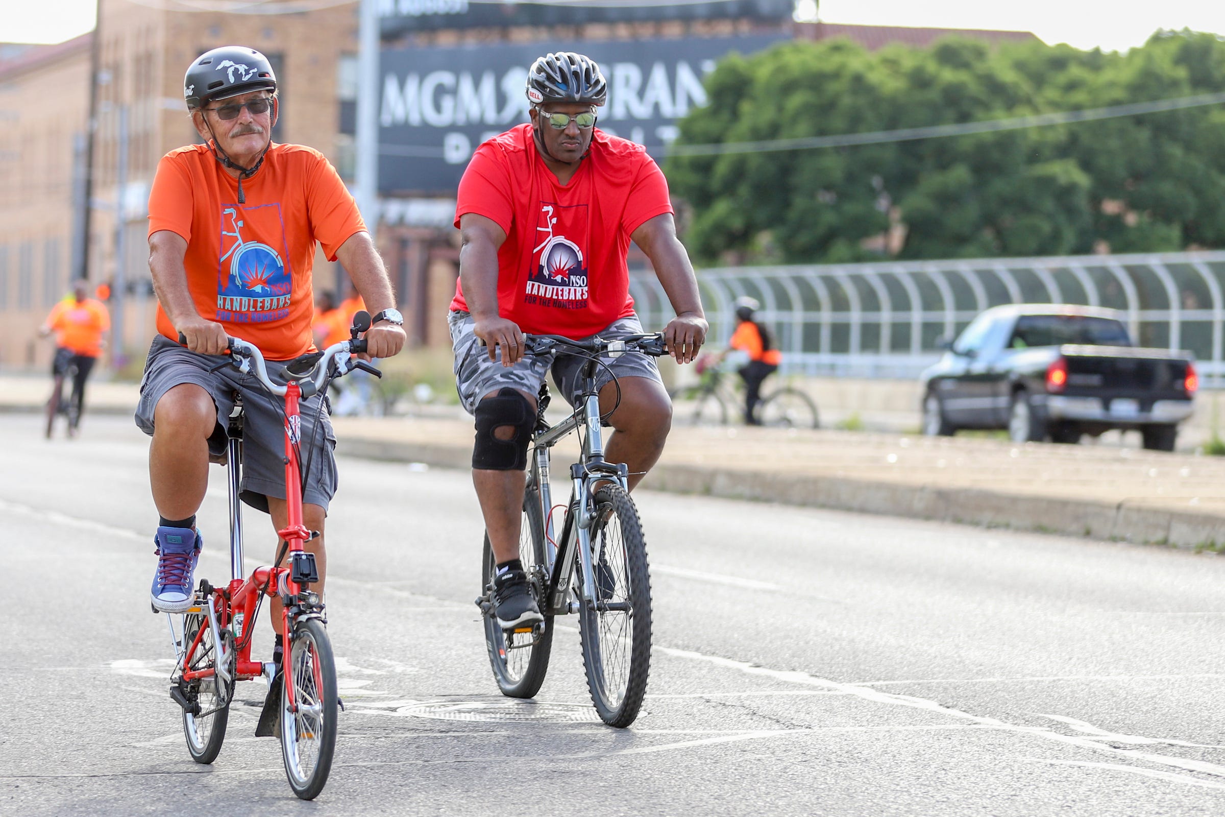 Thomas Page, of New Center Detroit and David Rudolph, 55, of Detroit lead the practice ride for Neighborhood Service Organizaiton's "Handlebars for the Homeless" bicycle tour fundraiser in Detroit on Thursday, July 28, 2022. The event raises funds for homeless people in Detroit and is back in person with a new 15-mile route beginning and ending at the iconic NSO Bell Building.